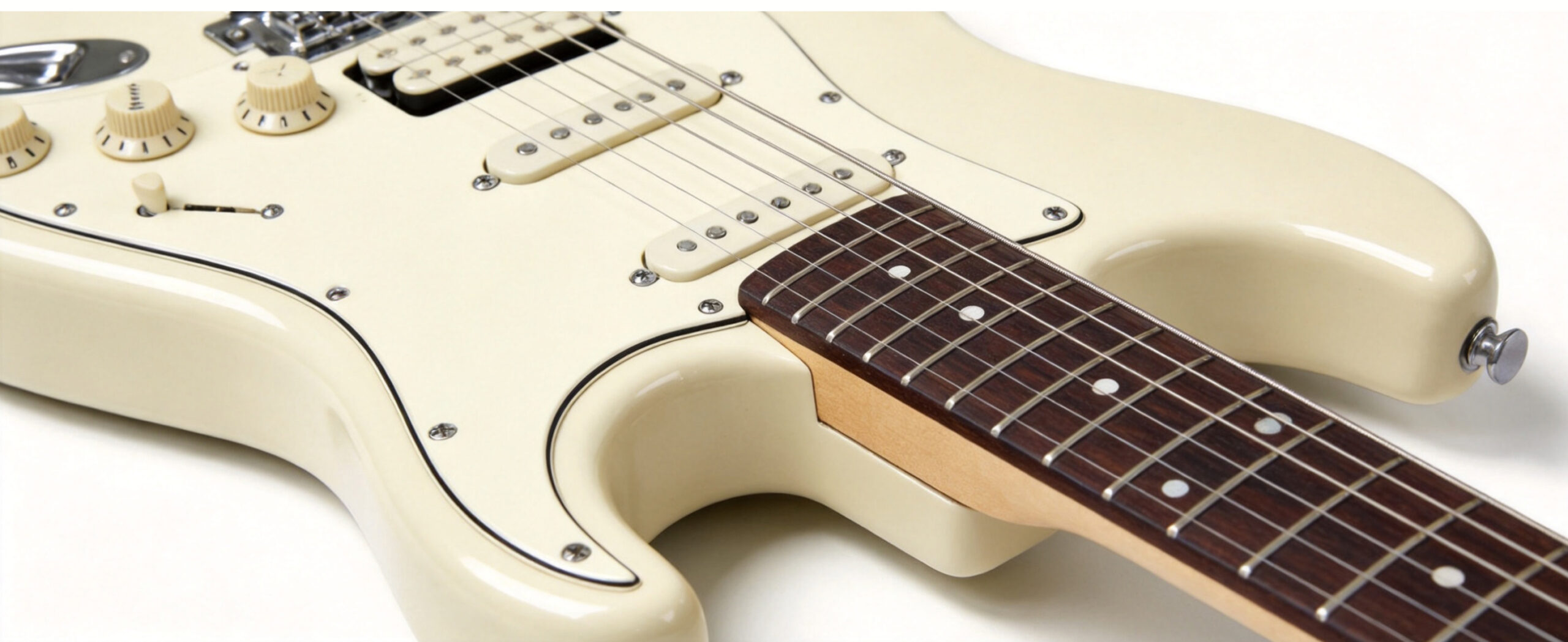 Detailed view of electric guitar body contour, maple neck and jatoba fingerboard construction