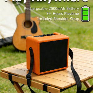 Rechargeable battery powered mini guitar amplifier with shoulder strap on an outdoor table