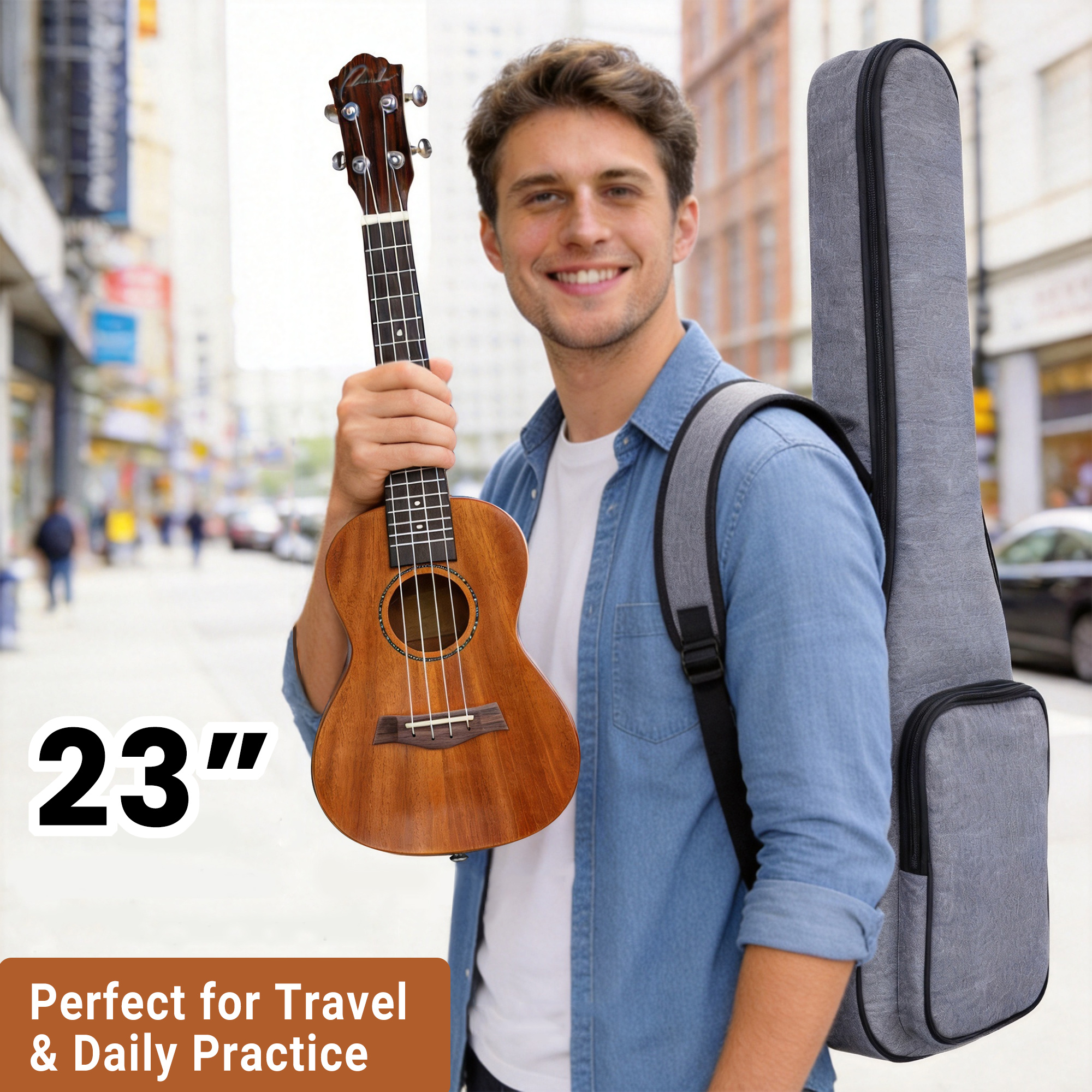A smiling young man carrying a gray ukulele gig bag on the street holding a 23 inch uke